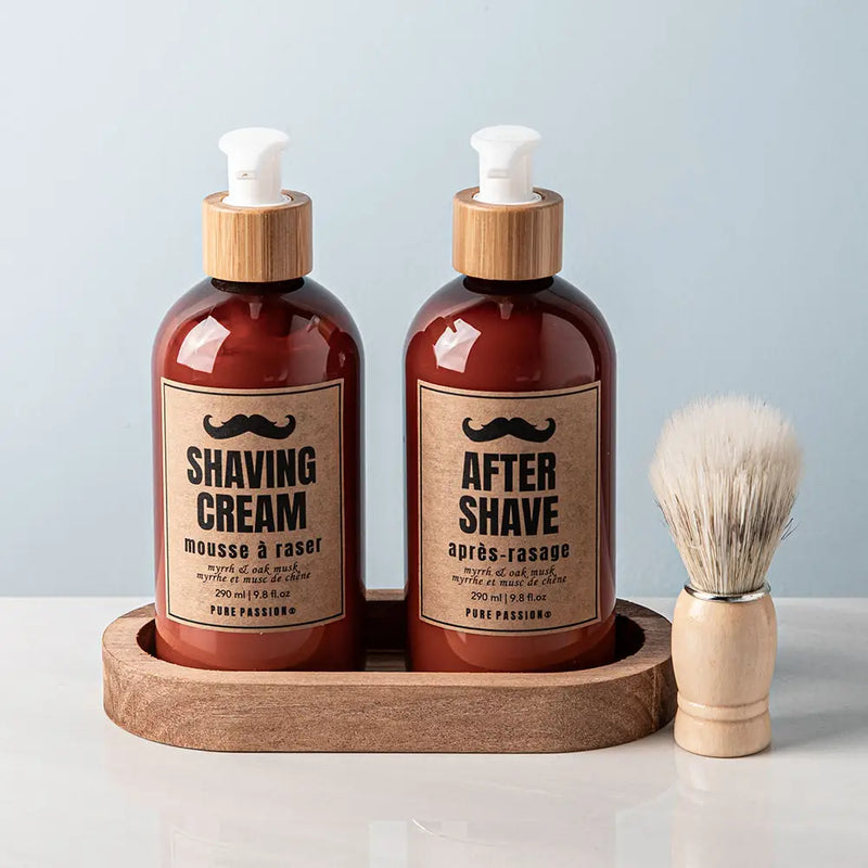 Two shaving bottles labeled 'Shaving Cream' and 'After Shave' on a wooden tray with a brush, against a light blue background.