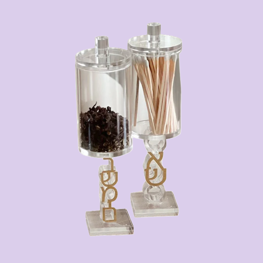 Two geometric glass candle holders on a white background