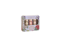 A rectangular decorative tin containing three small cylindrical bottles, shown on a plain white background. The tin has a floral print with lavender, roses, and green leaves, and the label reads 'Collection Soin des Manes Hair Magic' and 'Panachie Collection'.