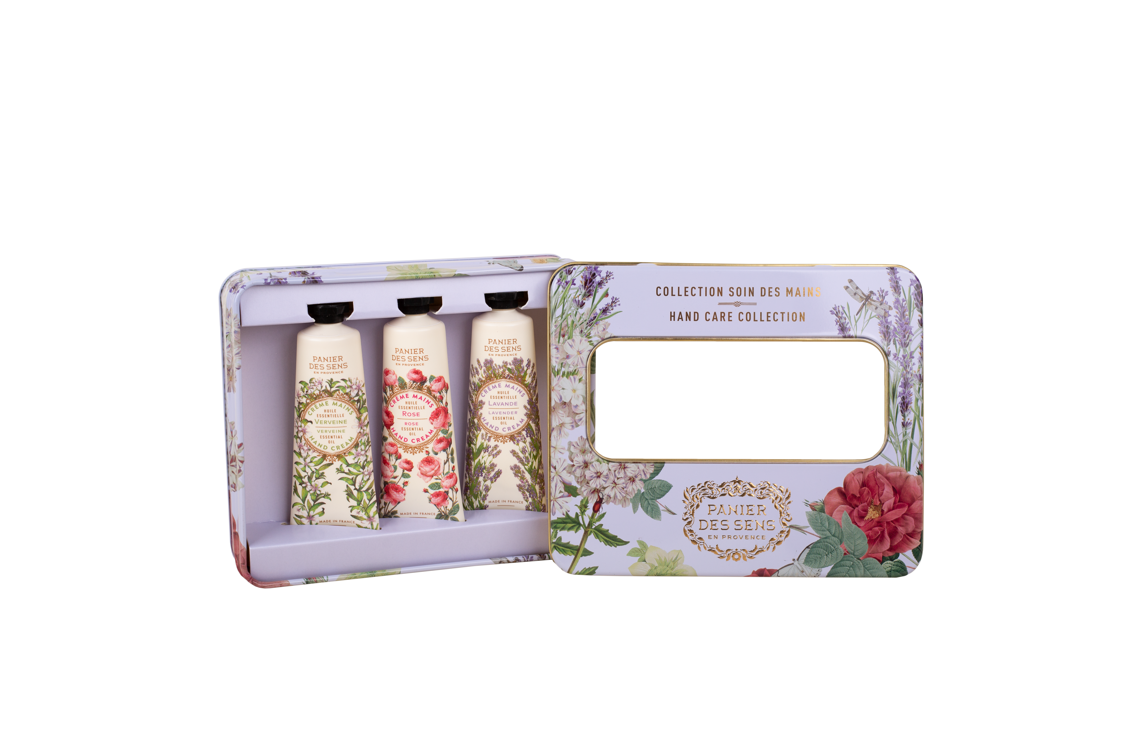 A hand care collection gift set in a floral-patterned metal tin, shown open with three squeeze tubes inside and a mirror on the outer panel.