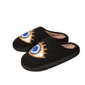 Black slippers with eye designs on a white background