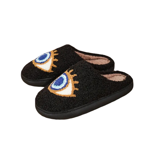 Black slippers with eye designs on a white background