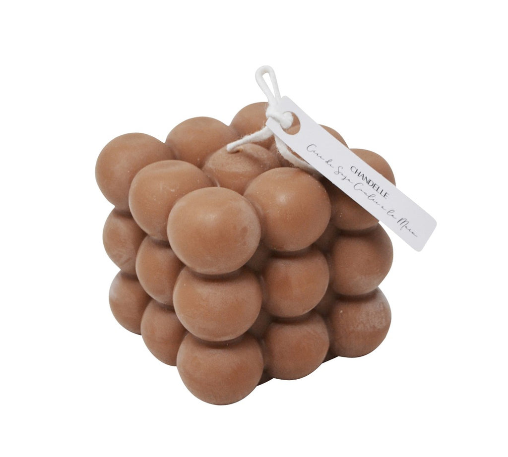 Brown bubble candle with a white tag on a white background