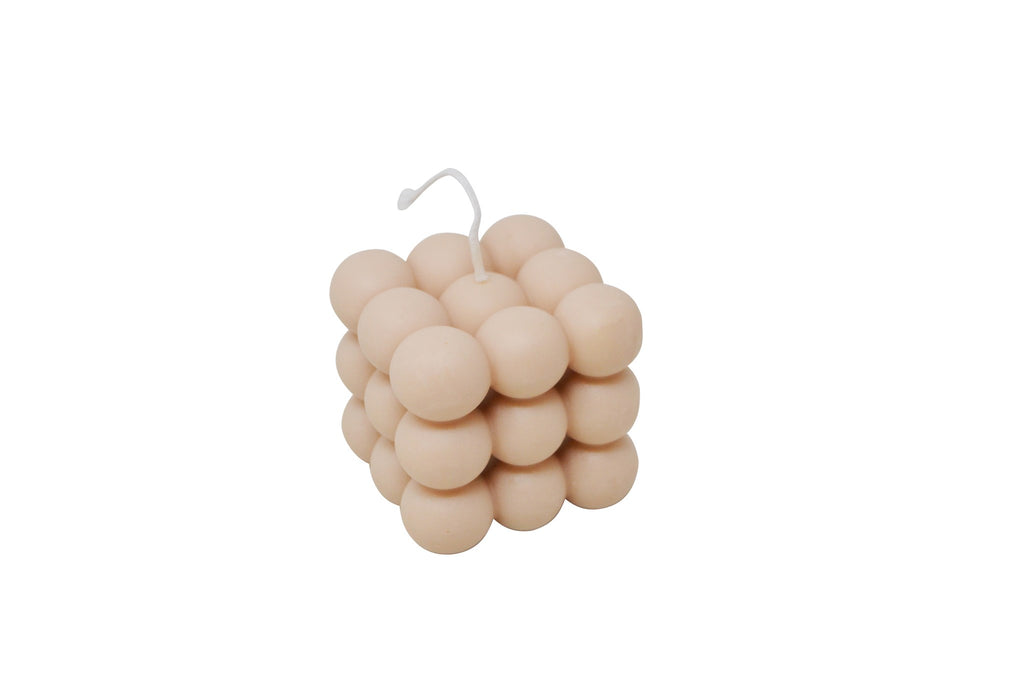 Beige bubble candle on a white background