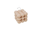 Beige bubble candle on a white background