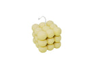 A pale yellow cube-shaped candle made of clustered round spheres, with a thin white wick at the top, shown on a plain white background.