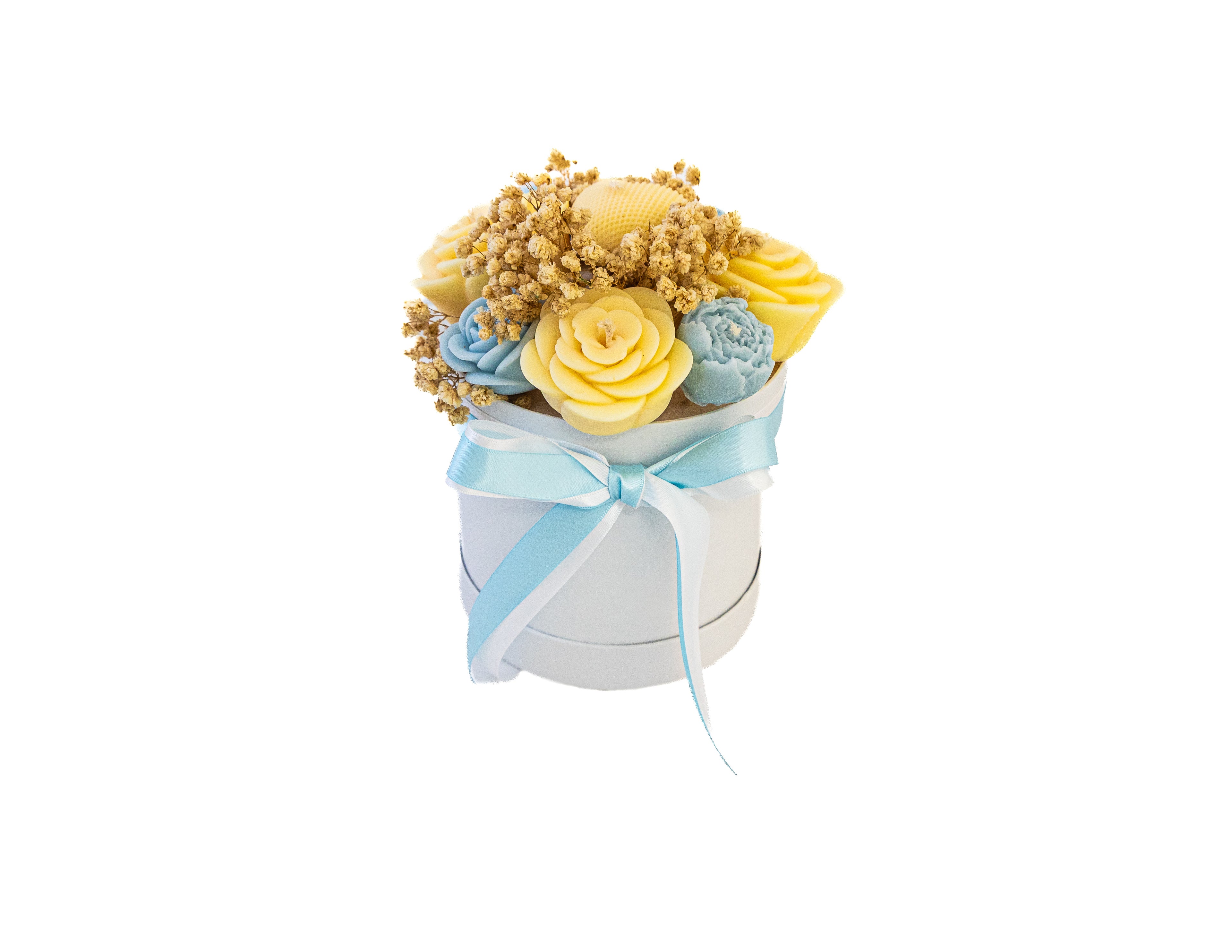 Decorative arrangement of yellow and blue candle flowers in a white container on a white background