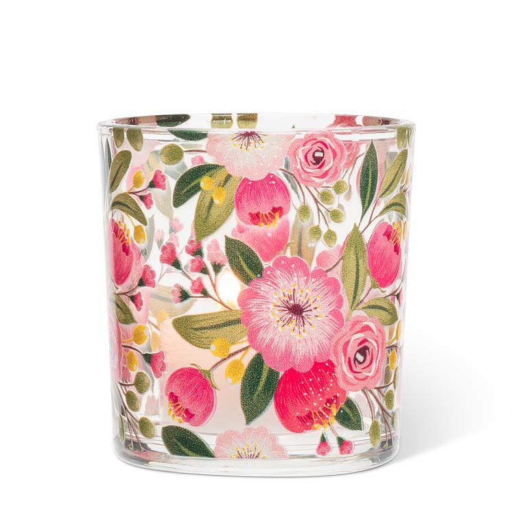 Glass candle with floral design on a white background