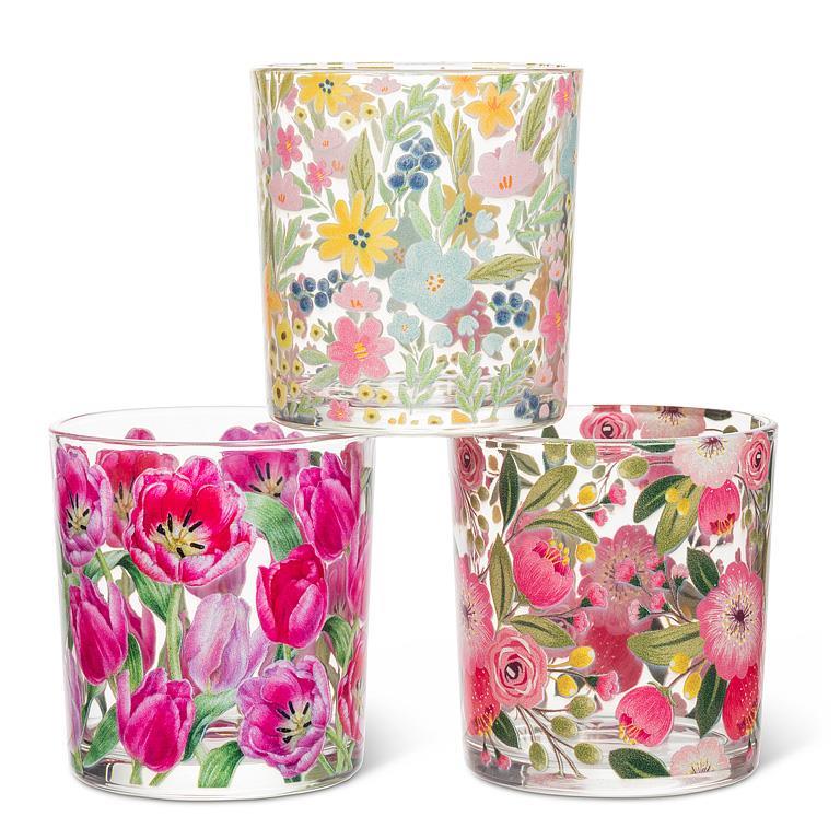 Three floral-patterned glass tumblers on a white background
