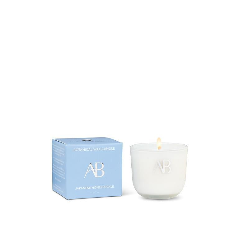 White candle with 'AB' logo next to a blue box on a white background