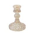 Decorative candle holder with intricate design on a white background