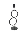 A black metal table lamp featuring a minimalist, abstract design with three stacked circular rings and a cylindrical shade on top, set against a plain white background.