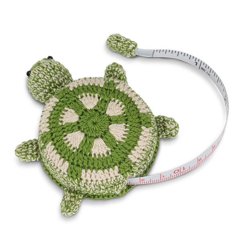 Crocheted turtle measuring tape on a white background