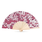 Handheld fan with pink and white floral pattern on a white background