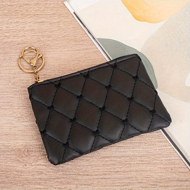 Black quilted coin purse with keychain on a wooden surface