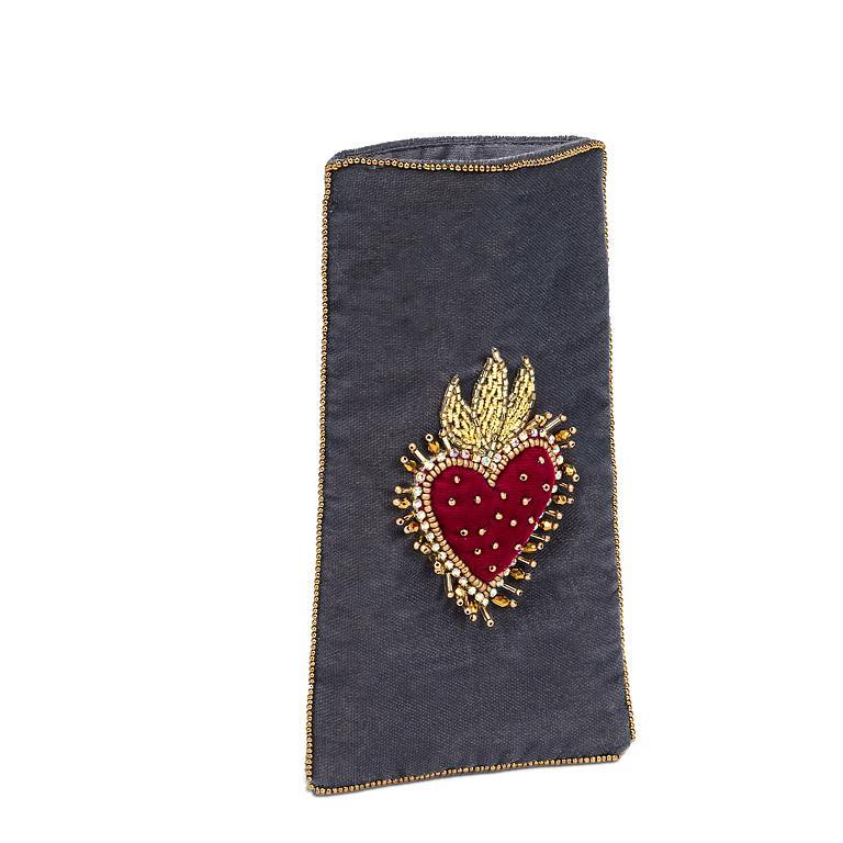 Dark blue pouch with a red heart design and gold accents on a white background