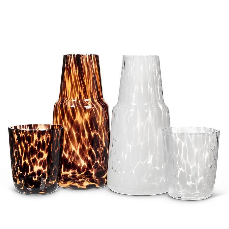 Set of glass vases with tortoiseshell and marble patterns on a white background
