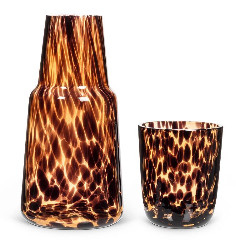 Two tortoiseshell patterned glass items on a white background