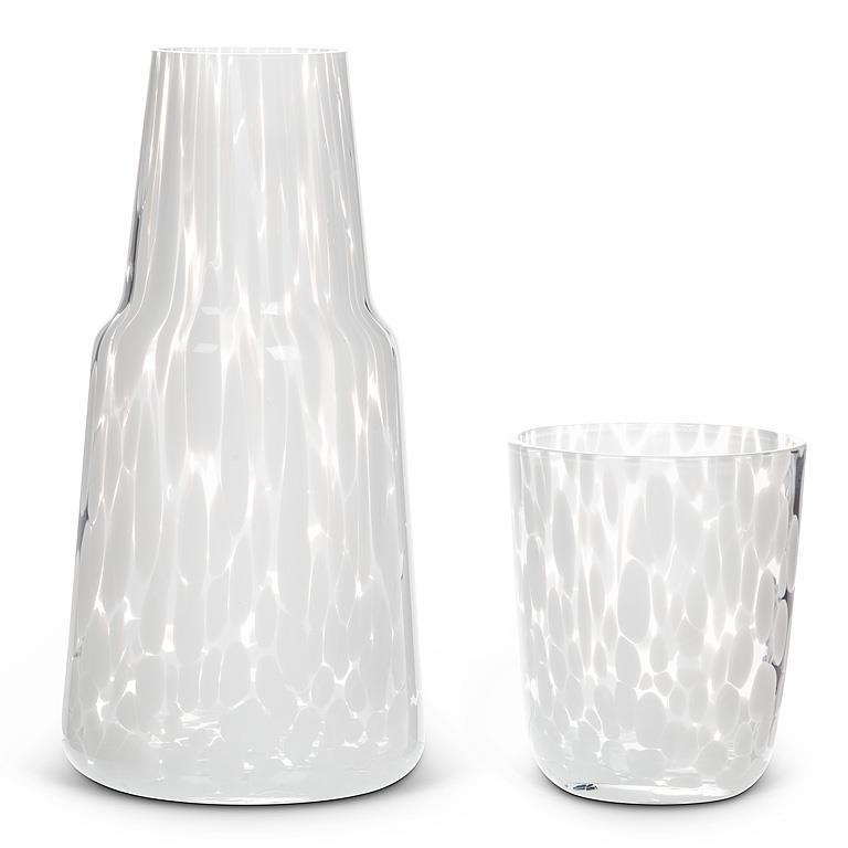 Clear glass carafe and tumbler set on a white background