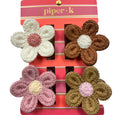 Set of four crocheted flower-shaped hair clips on a 'piper k' branded card.
