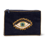 Black clutch with an eye-shaped embellishment on a white background