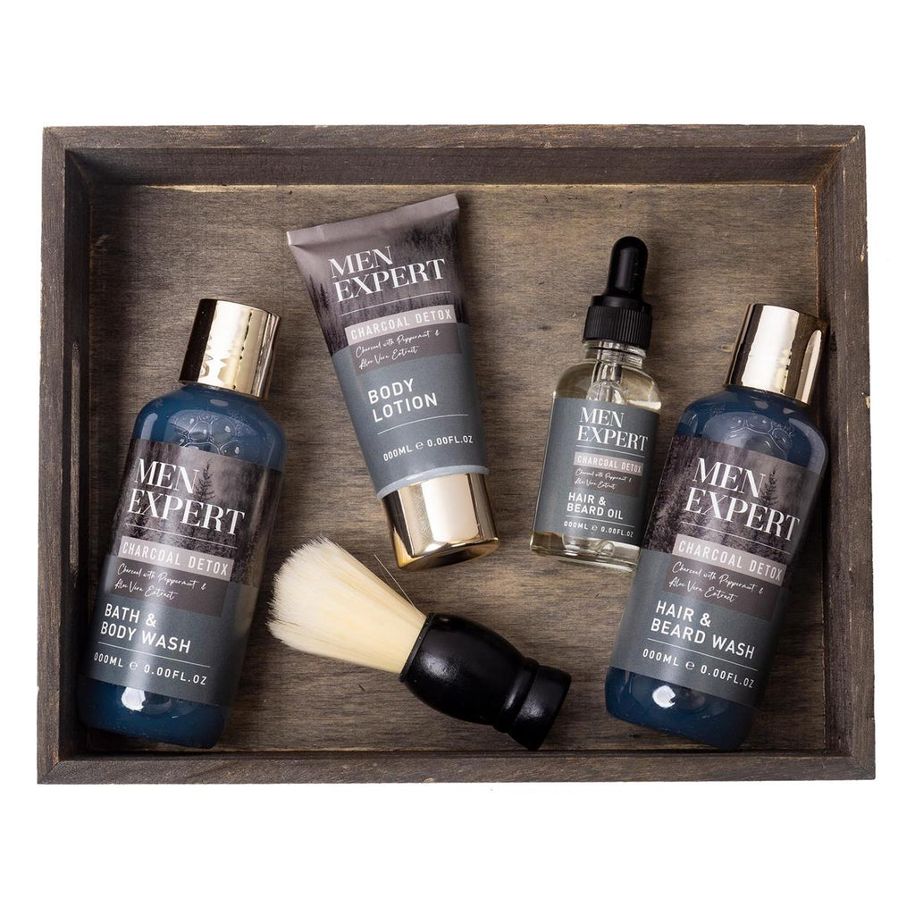 Men's grooming products including bath wash, lotion, oil, and brush in a wooden tray.