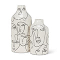 Two ceramic vases with abstract face designs on a white background