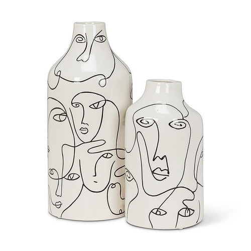 Two ceramic vases with abstract face designs on a white background