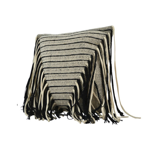 Black and white striped pillow with fringes on a white background