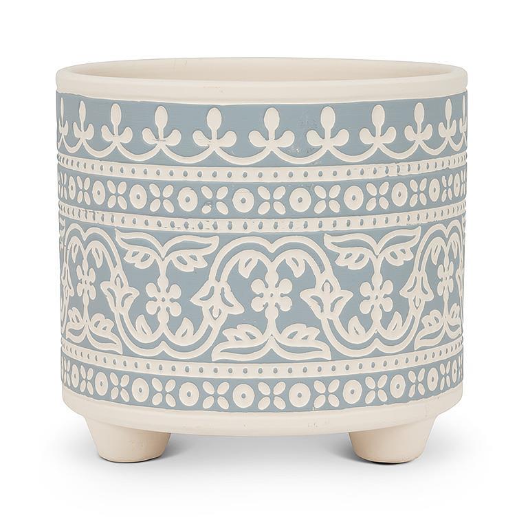 Decorative ceramic planter with blue and white pattern on a white background