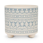 Decorative ceramic planter with blue and white pattern on a white background