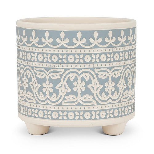 Decorative ceramic planter with blue and white pattern on a white background