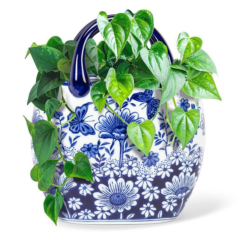 Blue and white floral-patterned planter with green vines on a white background