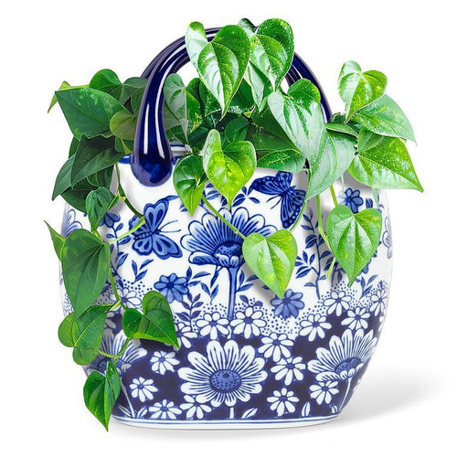 Blue and white floral-patterned planter with green vines on a white background