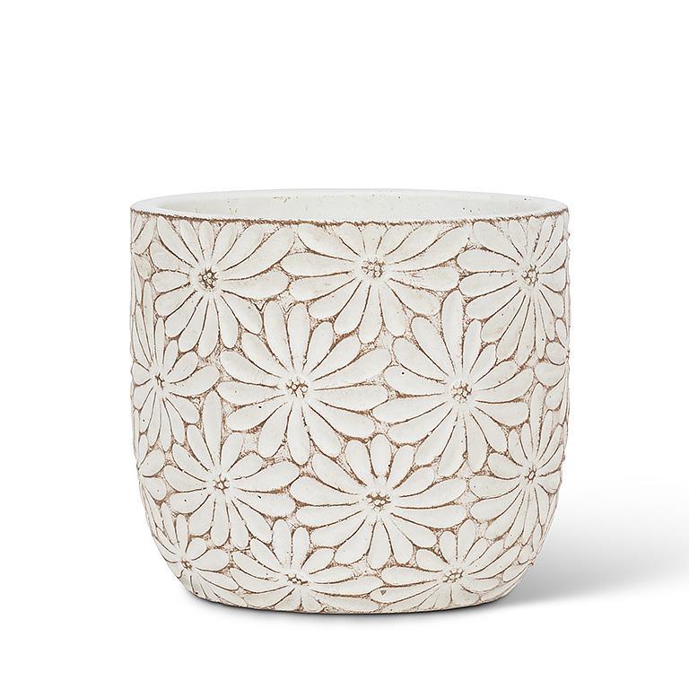 Decorative white ceramic planter with floral pattern on a white background