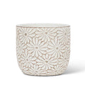 Decorative white ceramic planter with floral pattern on a white background