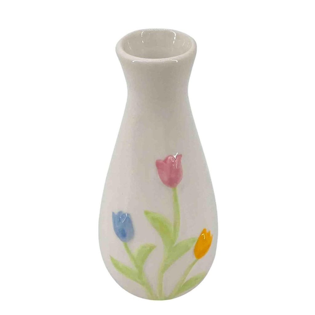 White ceramic vase with colorful floral designs on a white background