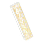 Decorative mezuzah with intricate cut-out gold pattern on a white background