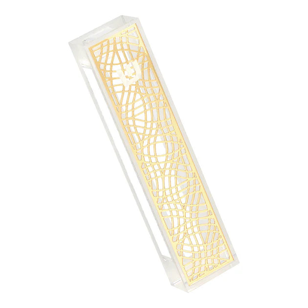 Decorative mezuzah with intricate cut-out gold pattern on a white background