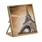 A square brass picture frame with a hinged back and stand, featuring a sepia-toned photograph of the Eiffel Tower. The frame is shown open on a white background.