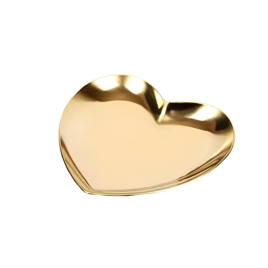 A shiny, metallic gold heart-shaped tray or dish on a solid white background.