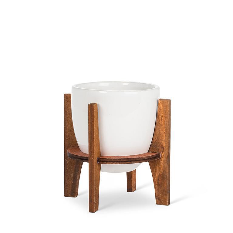 White ceramic planter with wooden stand on a white background