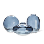 Three blue glass vases of different shapes on a white background
