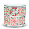 Decorative cylindrical vase with colorful geometric pattern on a white background
