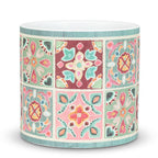 Decorative cylindrical vase with colorful geometric pattern on a white background