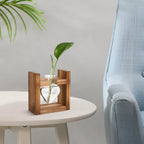 Wooden planter with a plant on a table next to a blue chair
