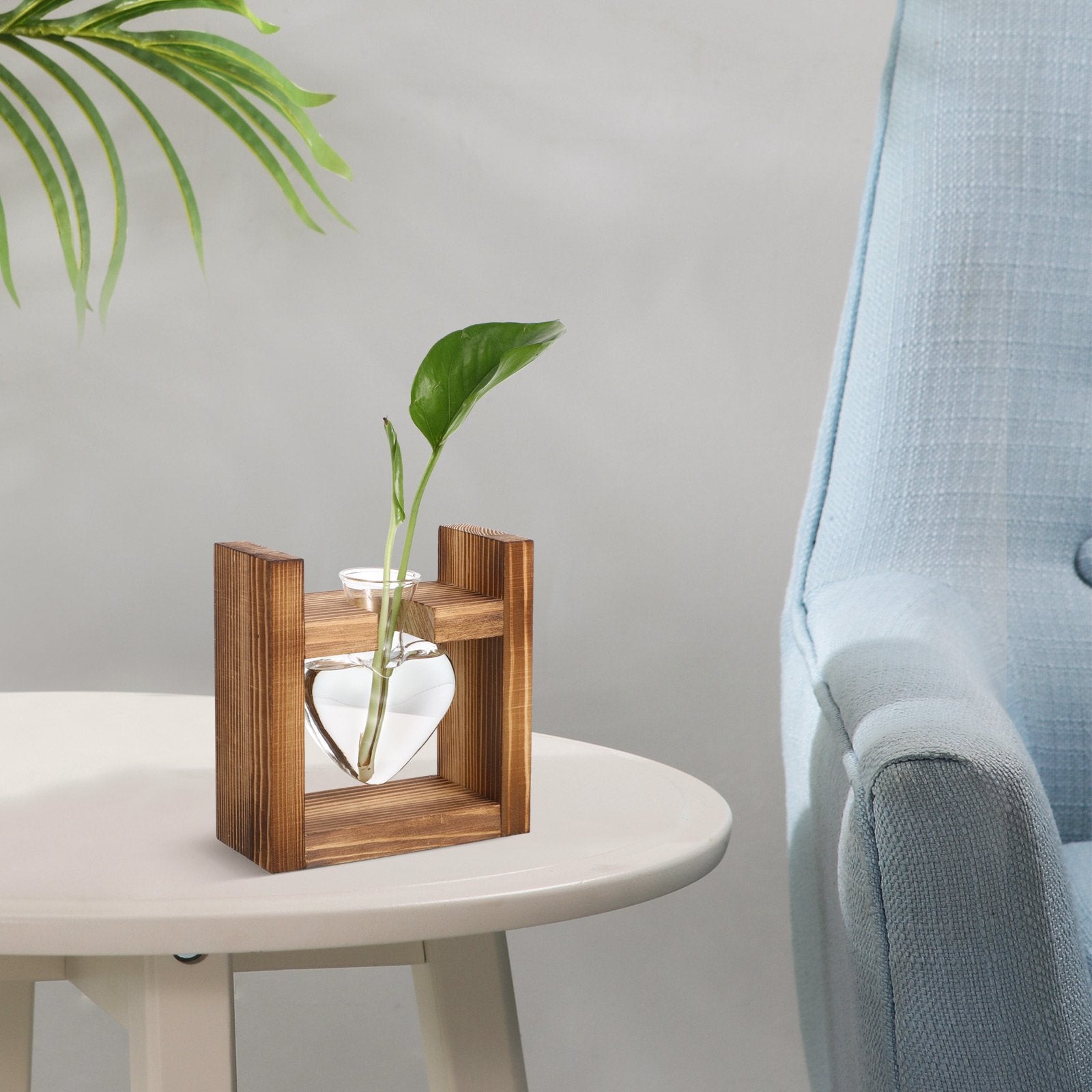 Wooden planter with a plant on a table next to a blue chair