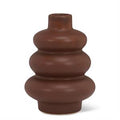 Brown ceramic vase with layered design on a white background