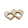 Two wooden heart-shaped napkin rings on a white background