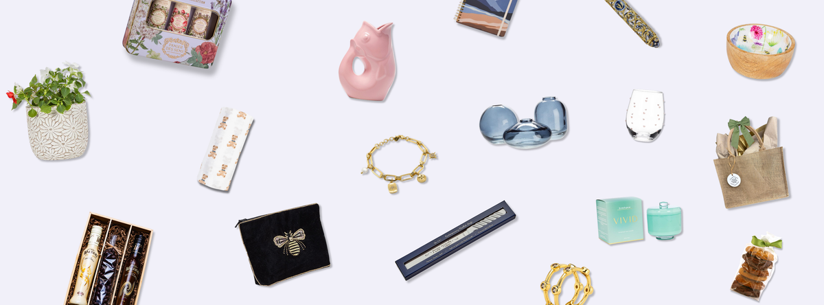 A pale purple background with a scattered assortments of gifts—home goods, jewellery, accessories, and more.